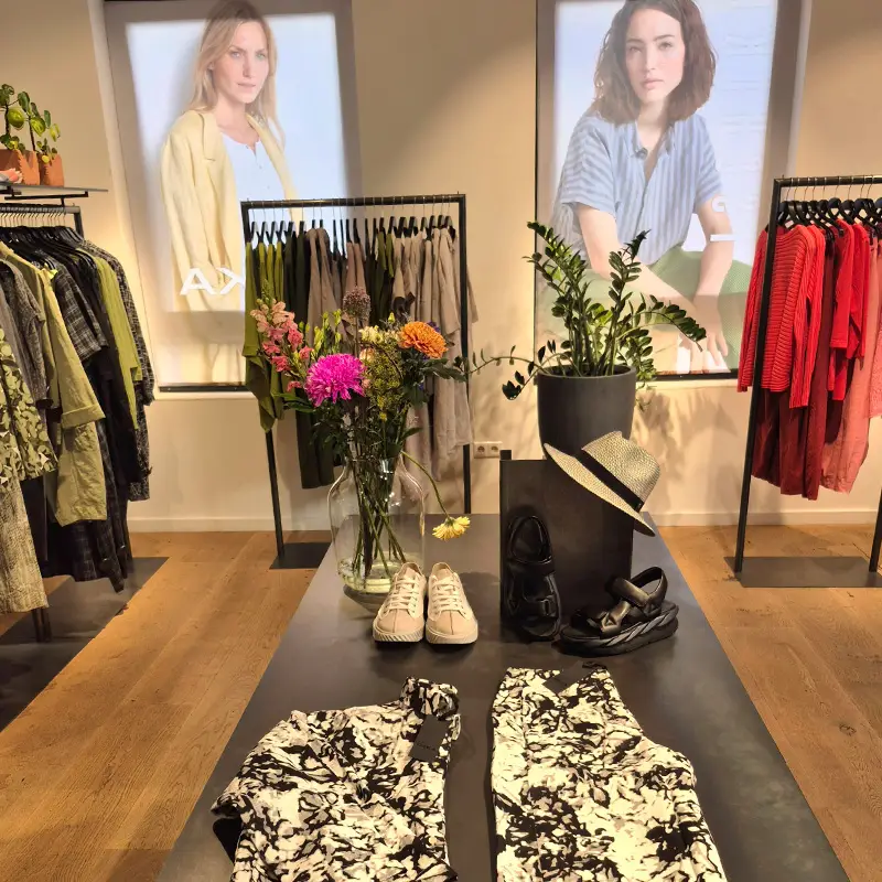 Clothing store display with floral arrangements